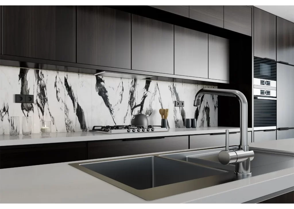 Modern kitchen with a sleek marble backsplash, black cabinetry, stainless steel fixtures, and a stylish sink, showcasing contemporary interior design.